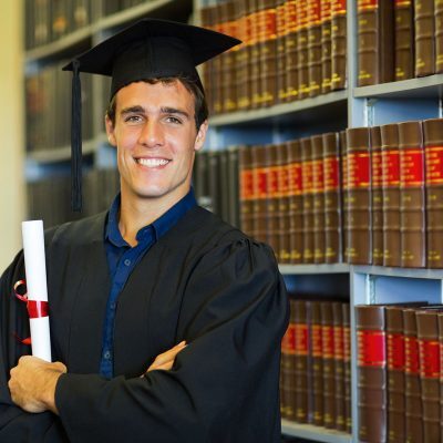 How to get an A in legal studies. Boy graduates in front of law books